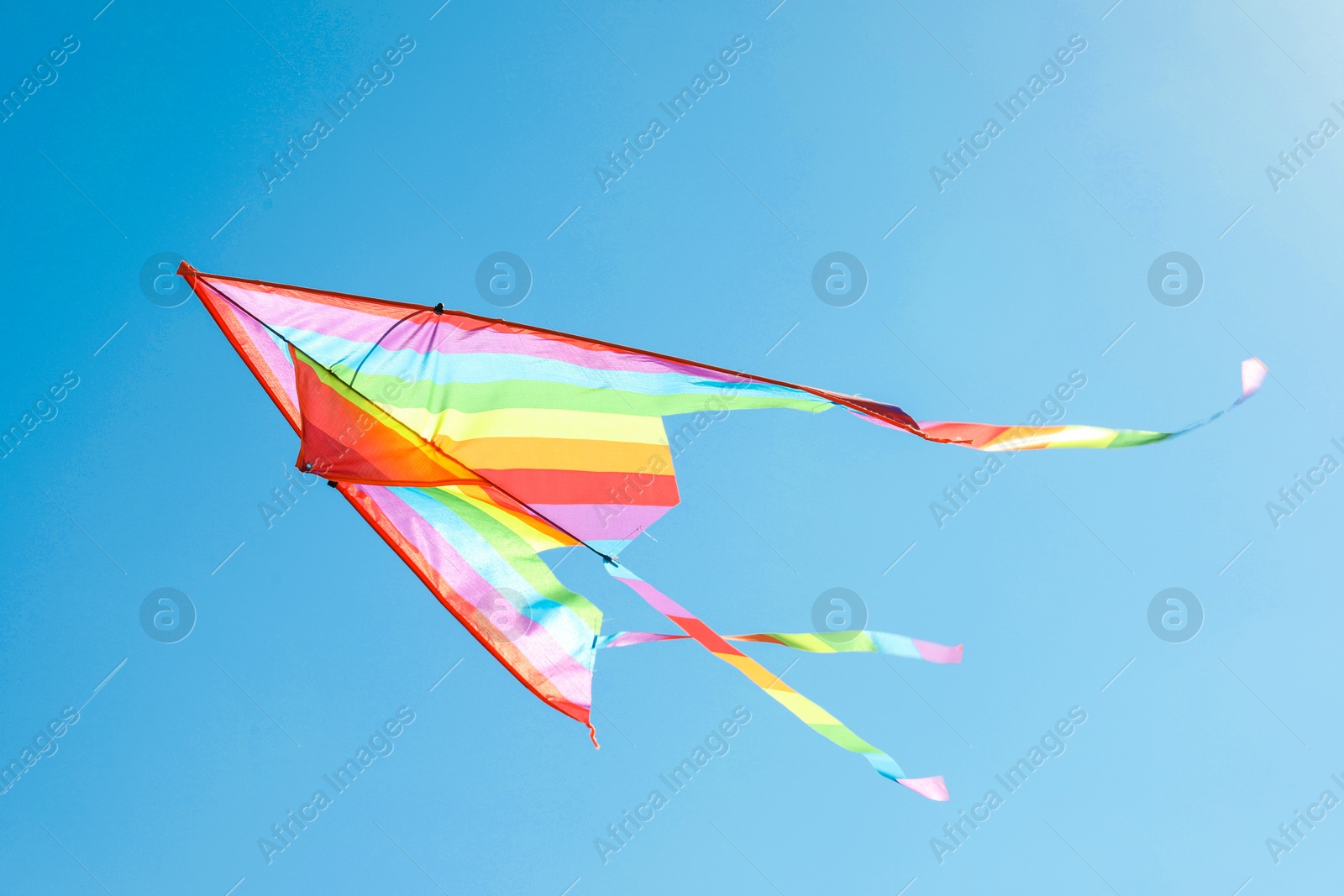 One colorful kite flying in blue sky Photo of One colorful kite flying in blue sky
