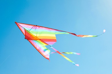 Photo of One colorful kite flying in blue sky