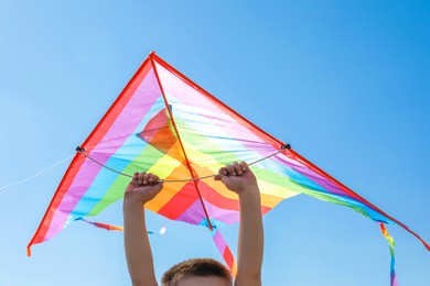Photo of Boy with kite on sunny day, closeup