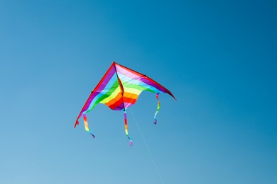 Photo of One colorful kite flying in blue sky