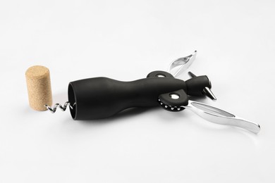 Wing corkscrew and cork on white background