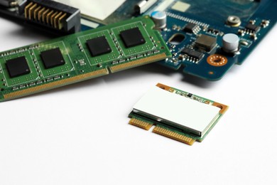 Photo of Wi-Fi card, RAM chip and computer circuit board isolated on white. Electronic engineering