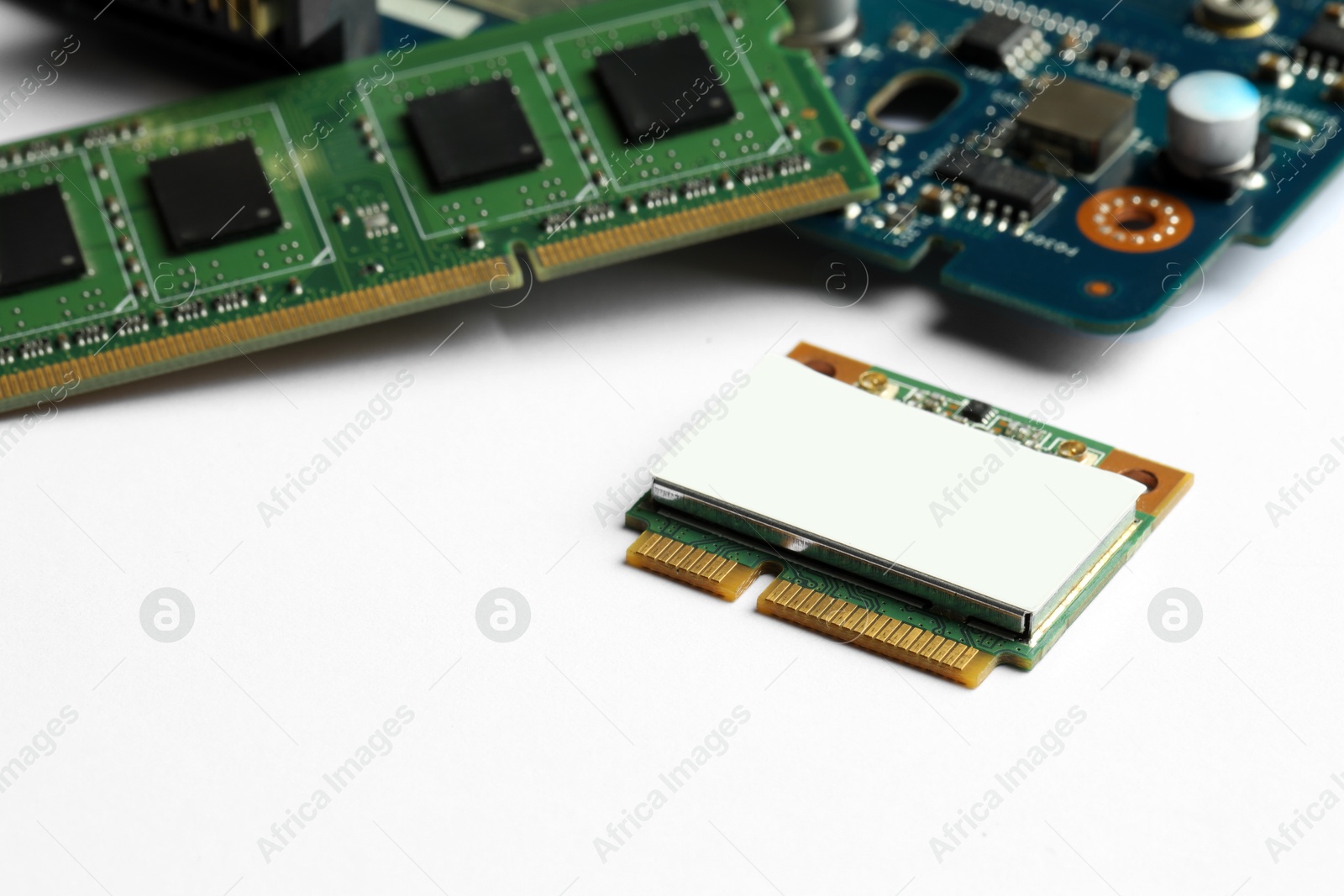 Photo of Wi-Fi card, RAM chip and computer circuit board isolated on white. Electronic engineering