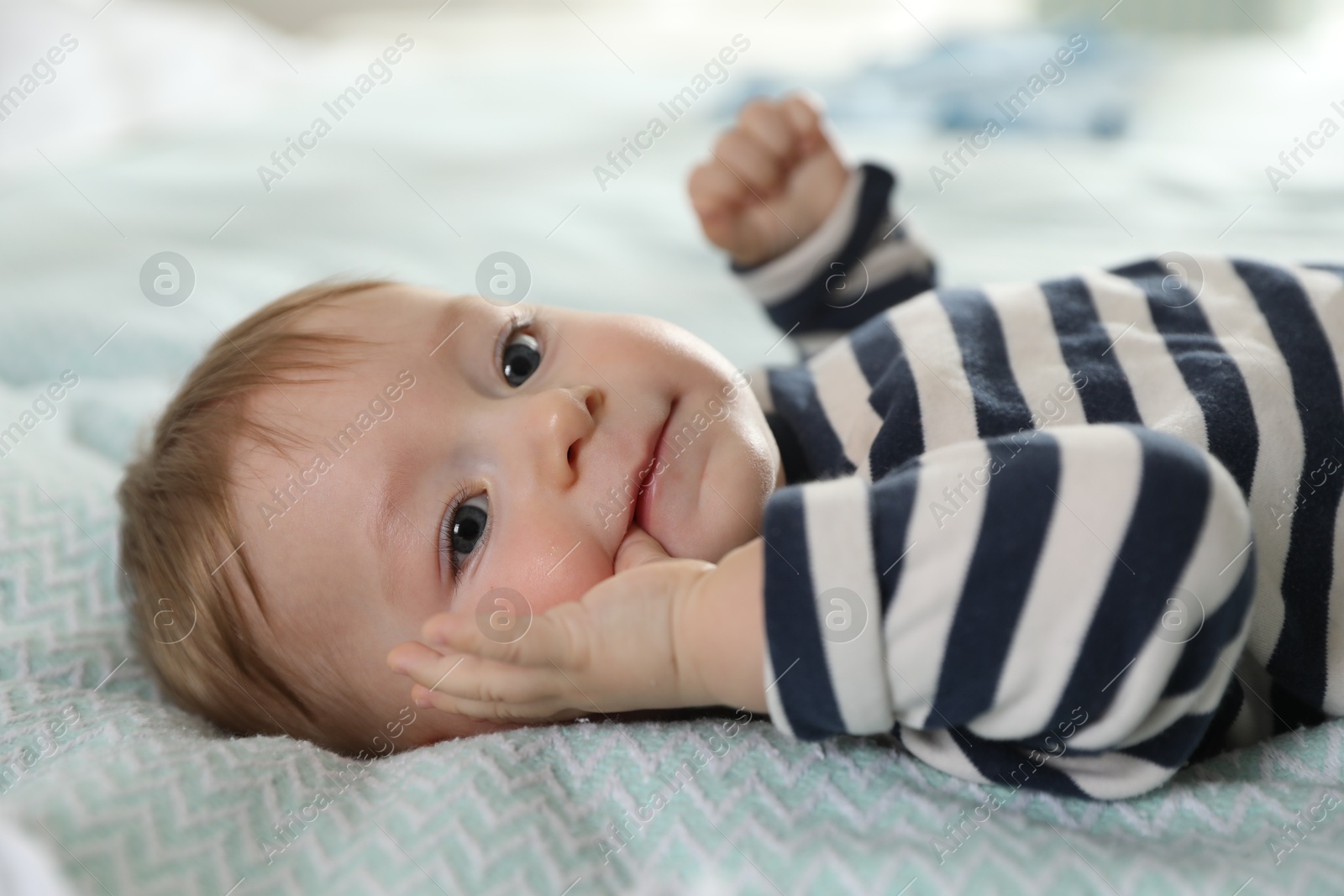 Photo of Cute little baby on bed at home