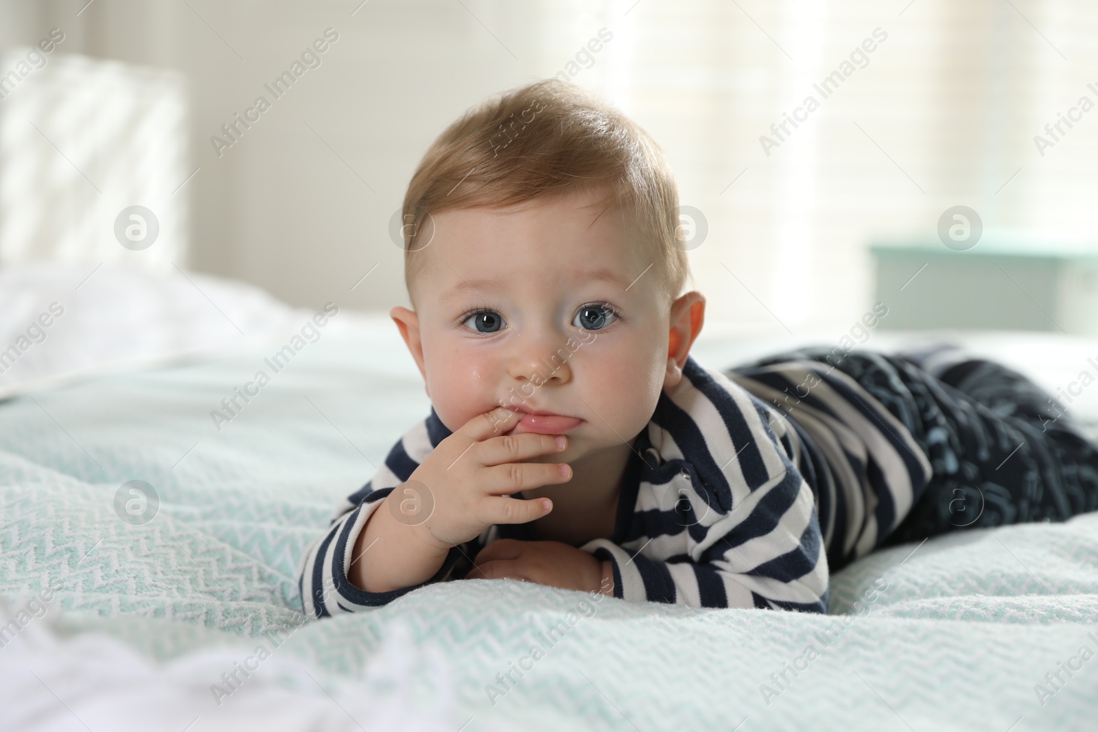 Photo of Cute little baby on bed at home