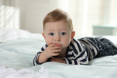 Photo of Cute little baby on bed at home