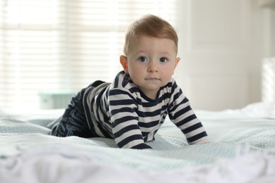 Photo of Cute little baby on bed at home