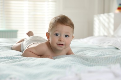 Photo of Cute little baby on bed at home