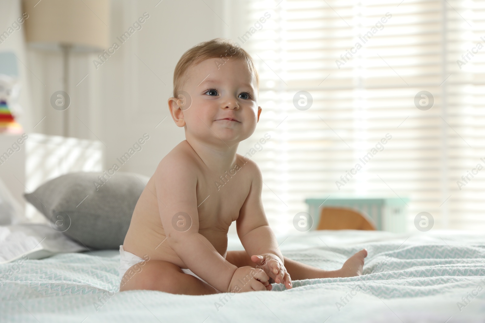 Photo of Cute little baby on bed at home