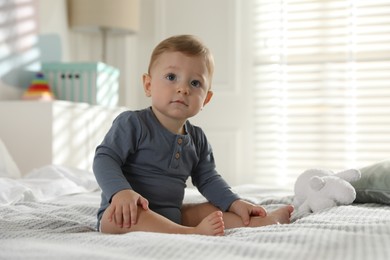 Photo of Cute little baby on bed at home