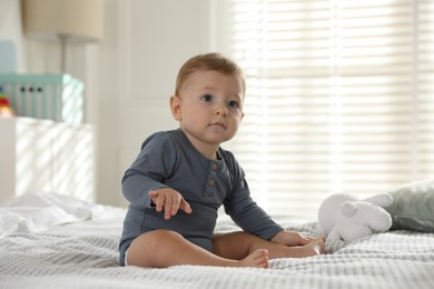 Photo of Cute little baby on bed at home