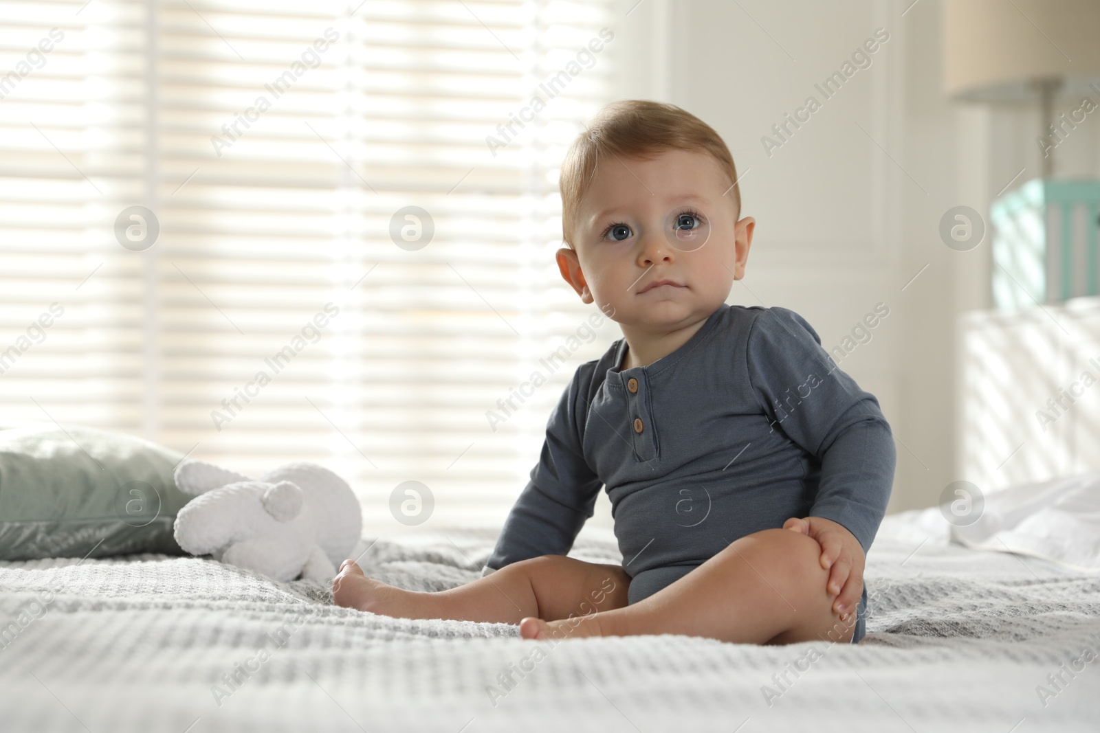 Photo of Cute little baby on bed at home