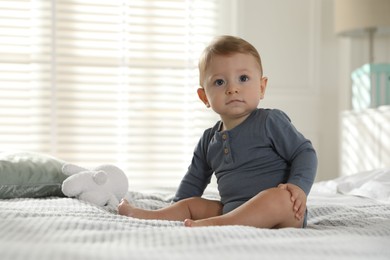 Cute little baby on bed at home