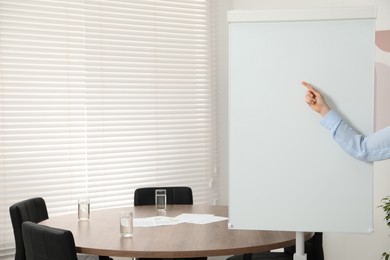 Photo of Woman near flip chart in office, closeup. Mockup for design