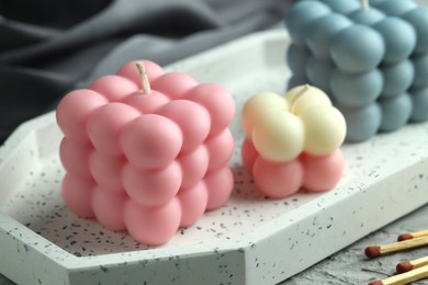 Photo of Beautiful bubble candles and matches on table, closeup