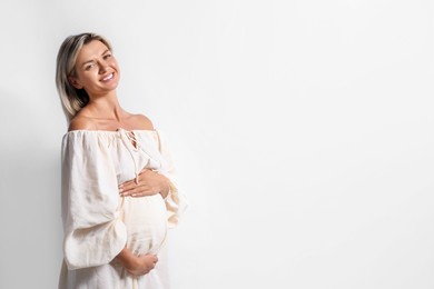 Photo of Portrait of beautiful pregnant woman on white background, space for text