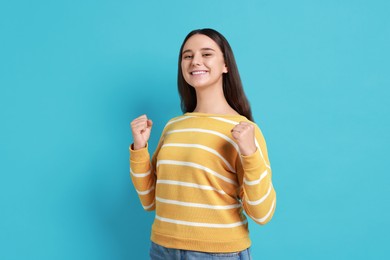 Photo of Happy young student on light blue background