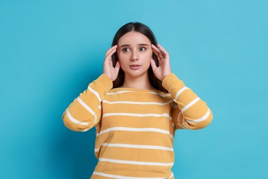 Photo of Stressful student before exam on light blue background