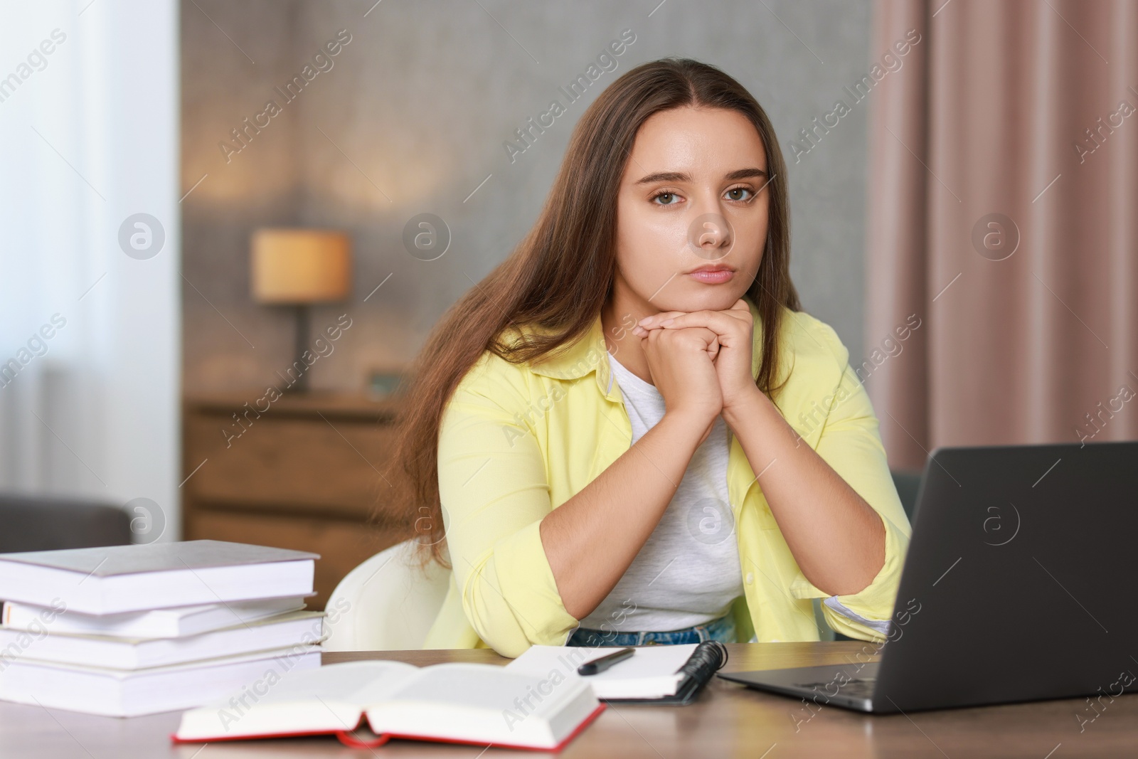 Photo of Young student having stress before exam at desk