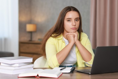 Photo of Young student having stress before exam at desk