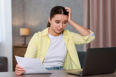 Photo of Young student having stress before exam at desk