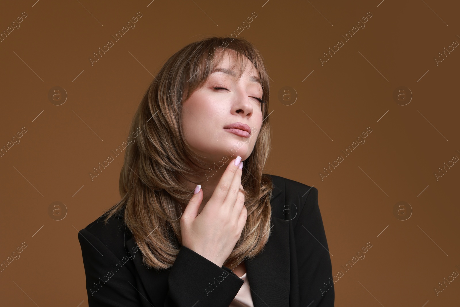 Photo of Attractive woman with stylish haircut on brown background