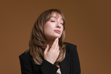 Photo of Attractive woman with stylish haircut on brown background