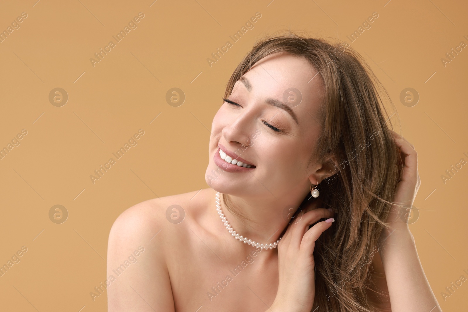 Photo of Attractive woman with stylish haircut on beige background