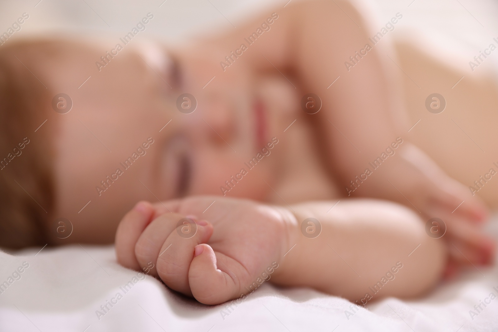 Photo of Cute little baby sleeping on bed, selective focus