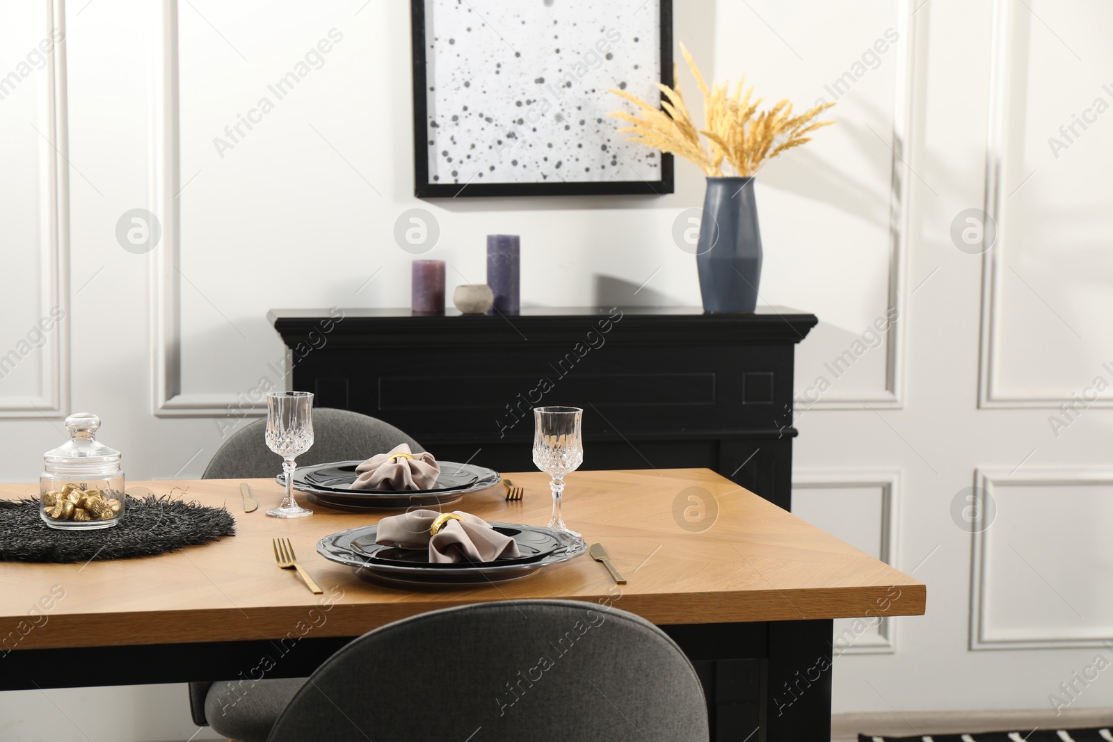 Photo of Stylish table setting with black dishware in dining room