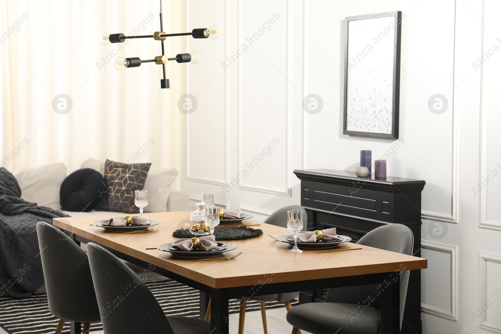 Photo of Stylish table setting with black dishware in dining room