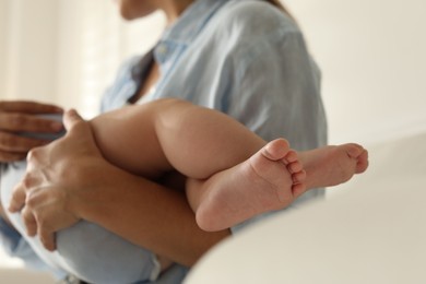 Photo of Mother with her sleeping baby indoors, closeup. Selective focus