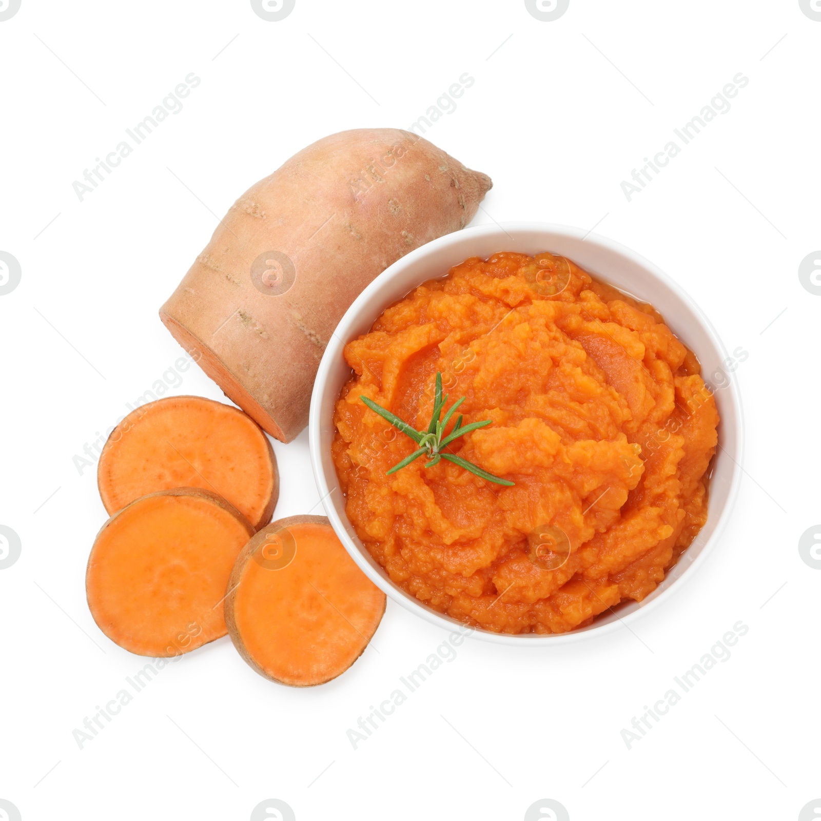 Photo of Tasty mashed sweet potato with rosemary in bowl and fresh cut vegetable isolated on white, top view