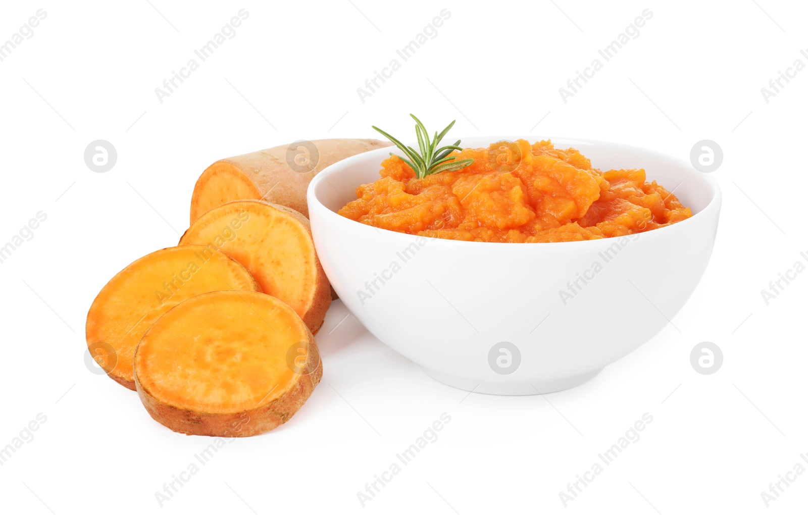 Photo of Tasty mashed sweet potato with rosemary in bowl and fresh cut vegetable isolated on white