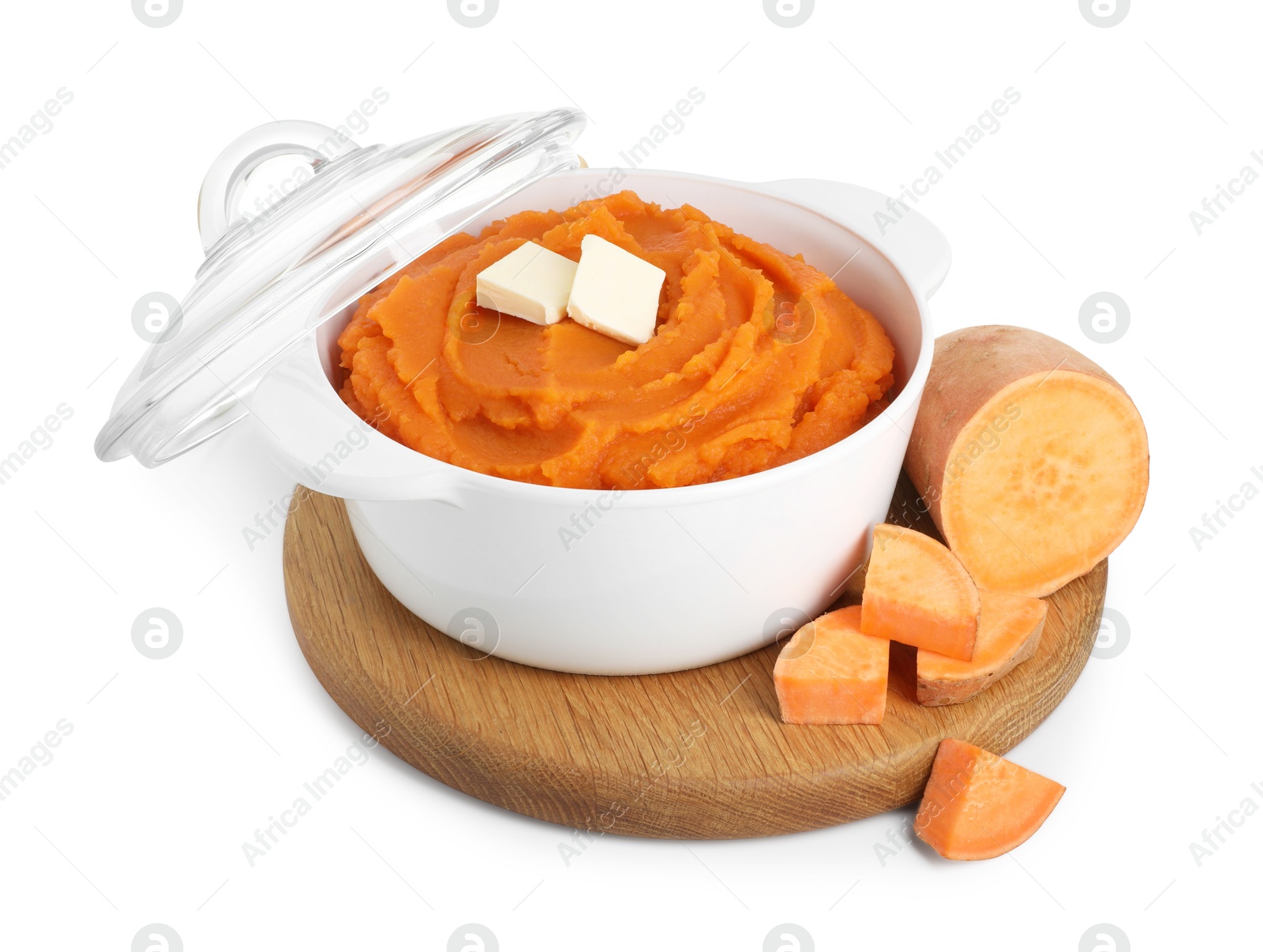 Photo of Tasty mashed sweet potato with butter in bowl and cut vegetable isolated on white