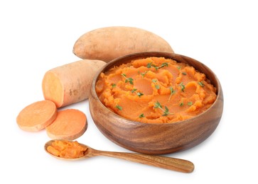 Photo of Tasty mashed sweet potato with thyme in bowl, spoon and fresh vegetables isolated on white