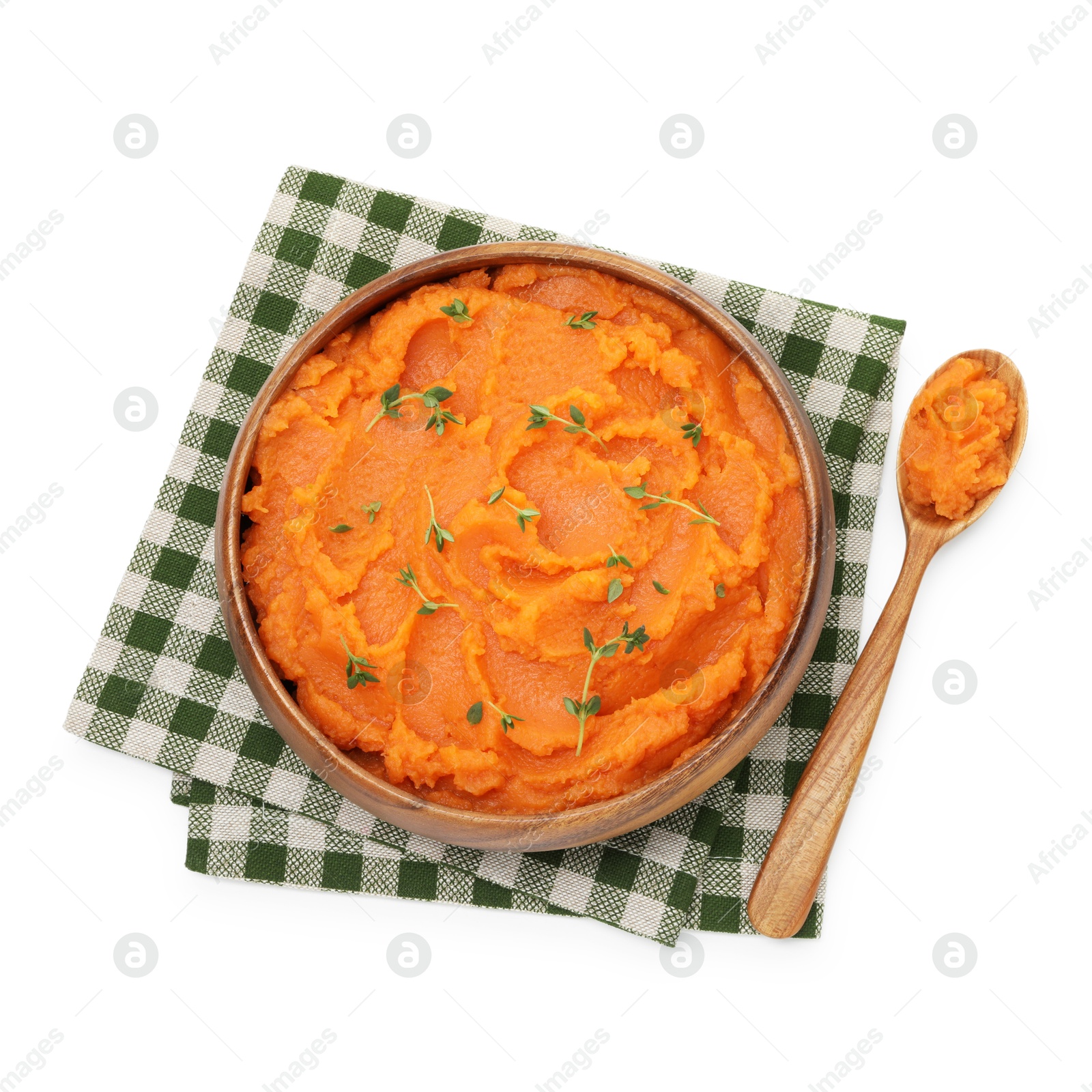 Photo of Tasty mashed sweet potato with thyme in bowl and spoon isolated on white, top view