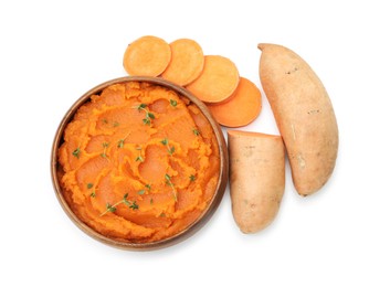 Photo of Tasty mashed sweet potato with thyme in bowl and fresh vegetables isolated on white, top view