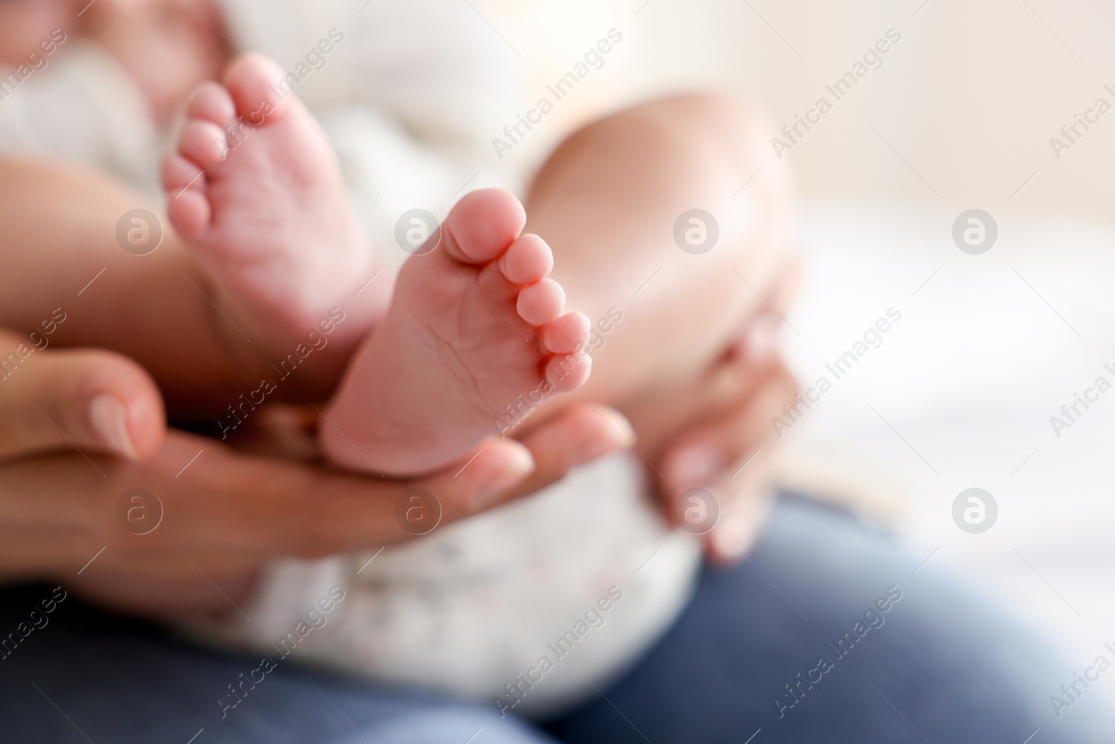 Photo of Mother with her cute little baby at home, closeup. Space for text