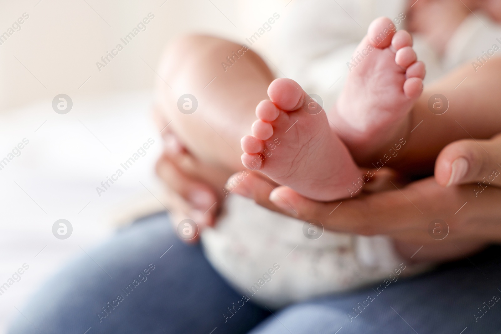 Photo of Mother with her cute little baby at home, closeup. Space for text