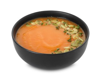 Photo of Delicious sweet potato soup with pumpkin seeds in bowl isolated on white