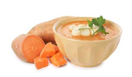 Photo of Delicious sweet potato soup with croutons in bowl and fresh vegetables isolated on white