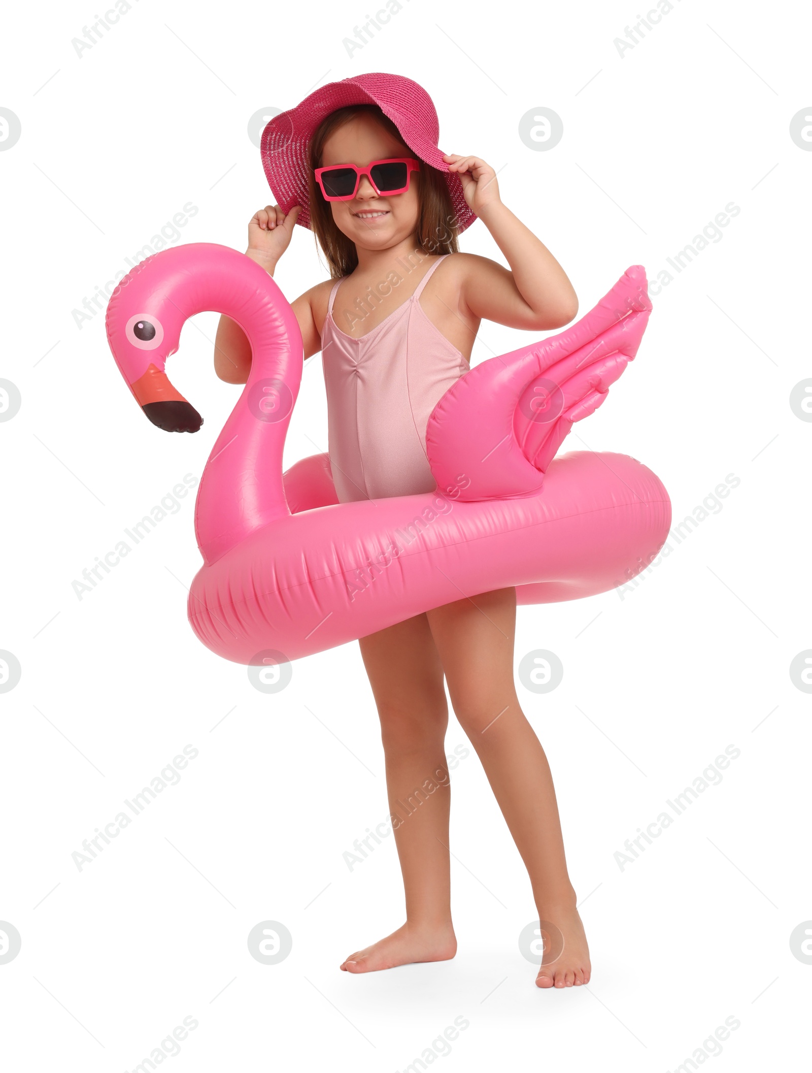 Photo of Cute little girl in swimsuit with inflatable ring on white background