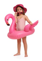 Photo of Cute little girl in swimsuit with inflatable ring on white background