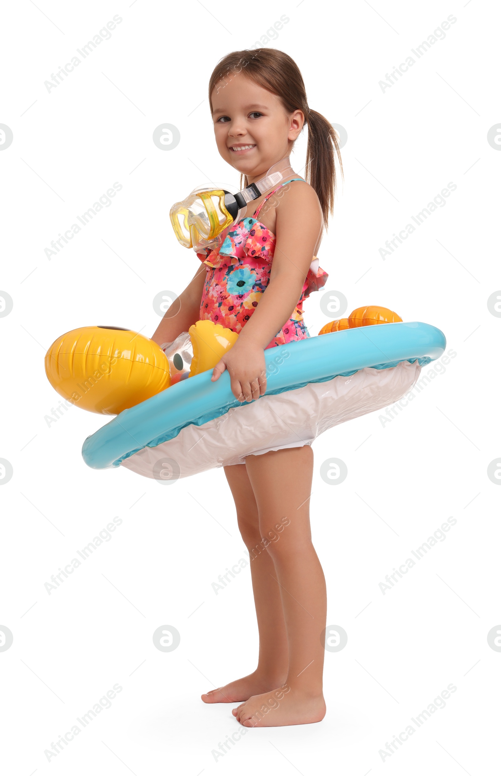 Photo of Cute little girl in swimsuit with inflatable ring on white background