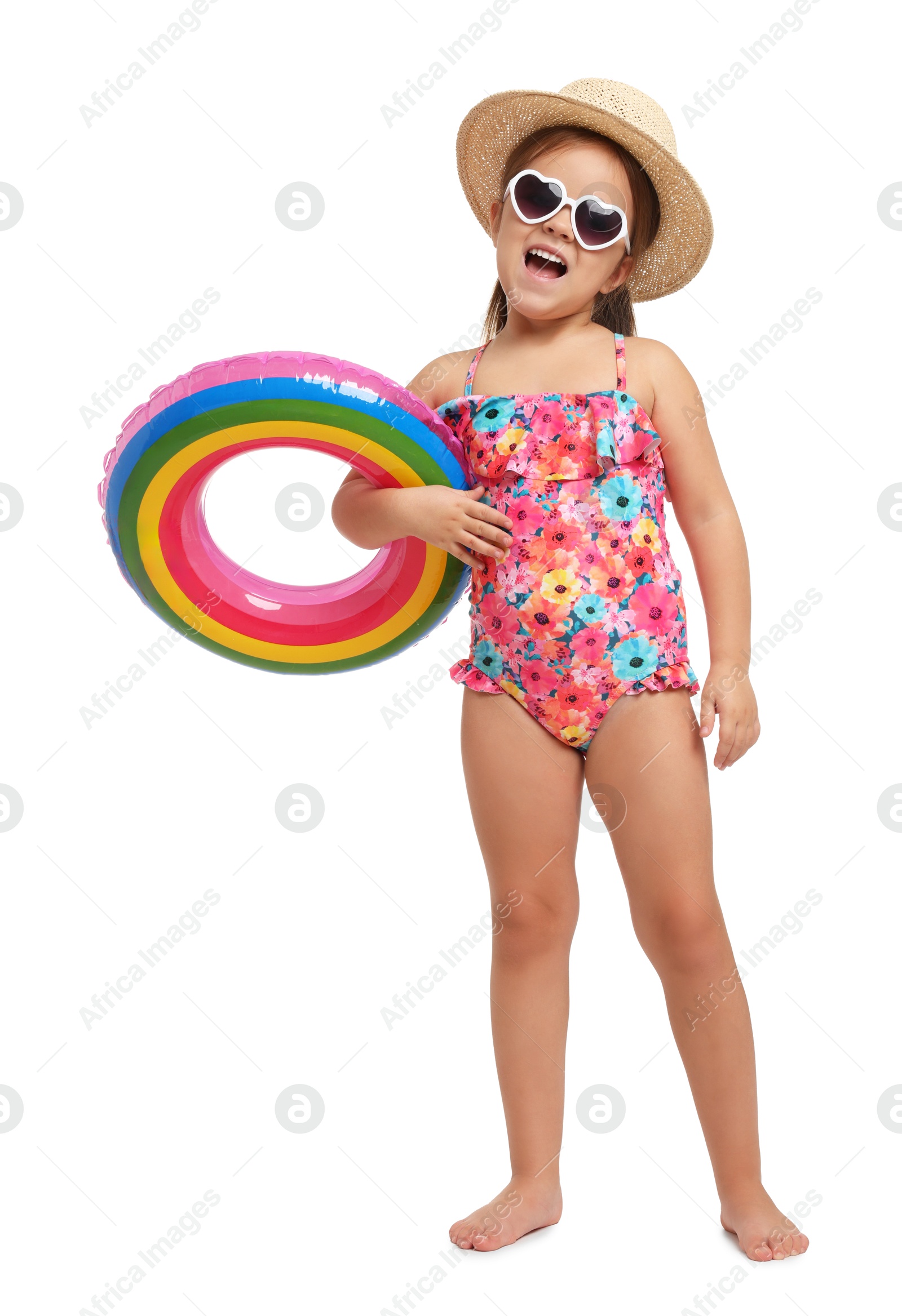 Photo of Cute little girl in swimsuit with straw hat and inflatable ring on white background