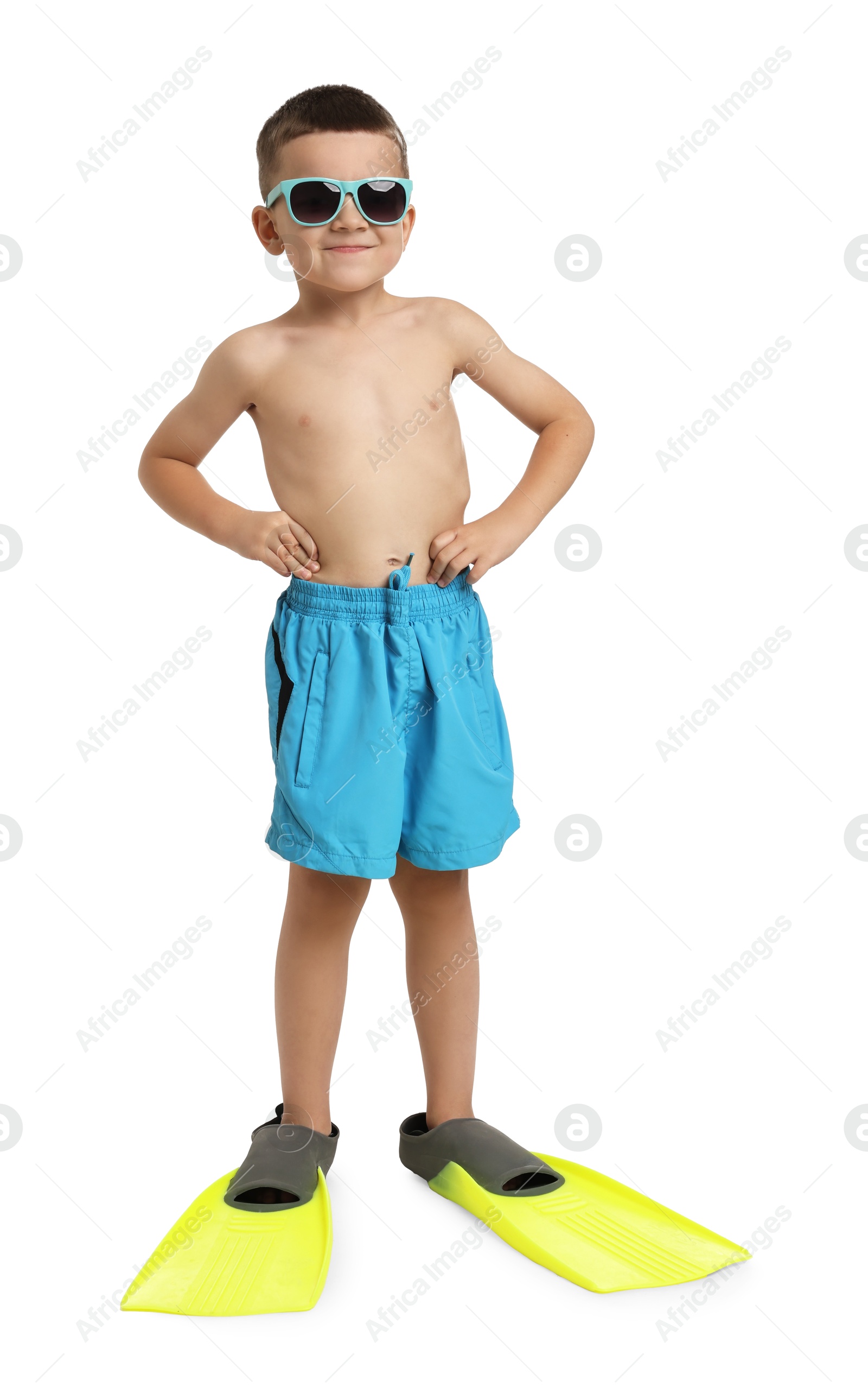 Photo of Cute little boy in beachwear with sunglasses and fins on white background