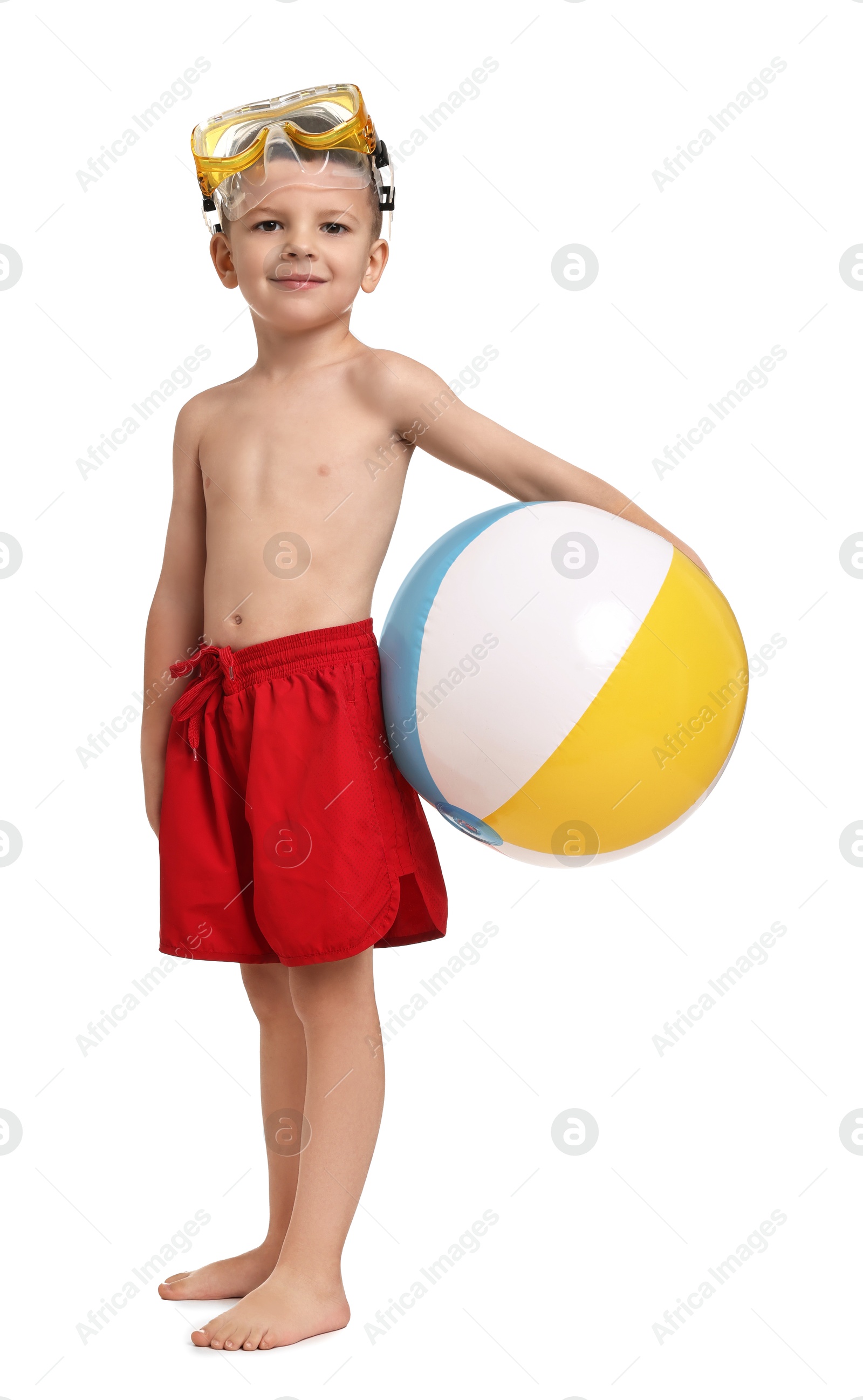 Photo of Cute little boy in beachwear with inflatable ball and mask on white background