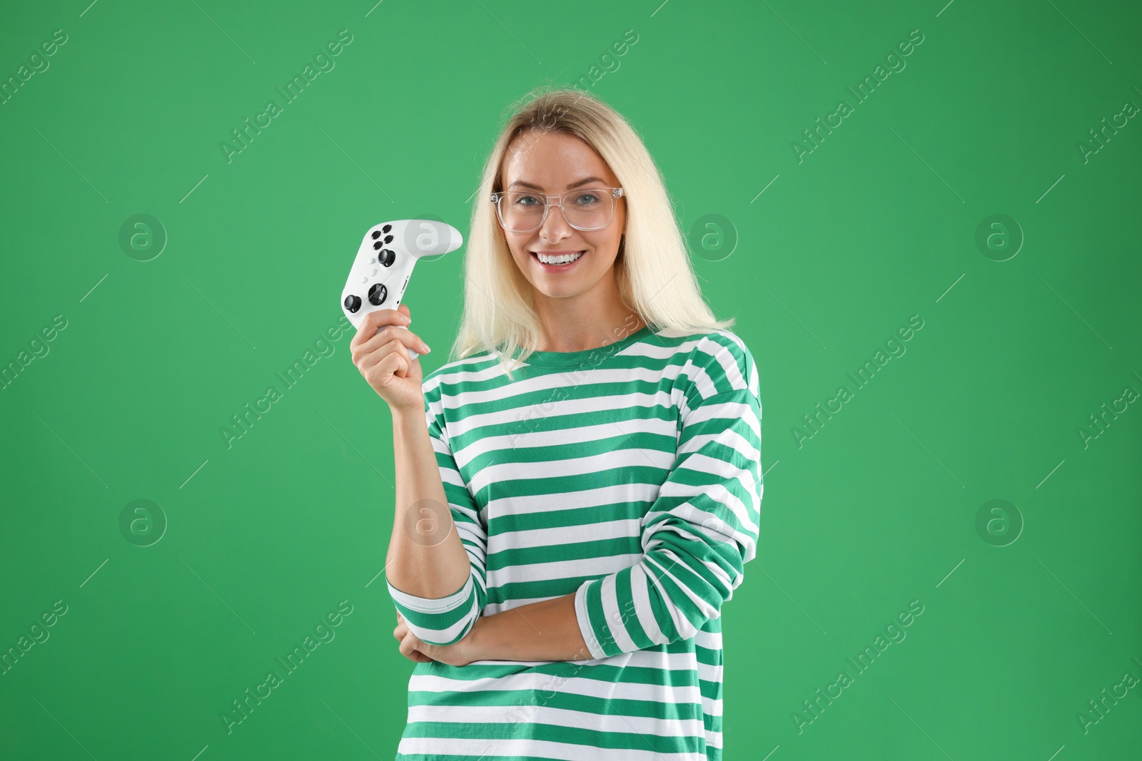 Photo of Happy woman with controller on green background