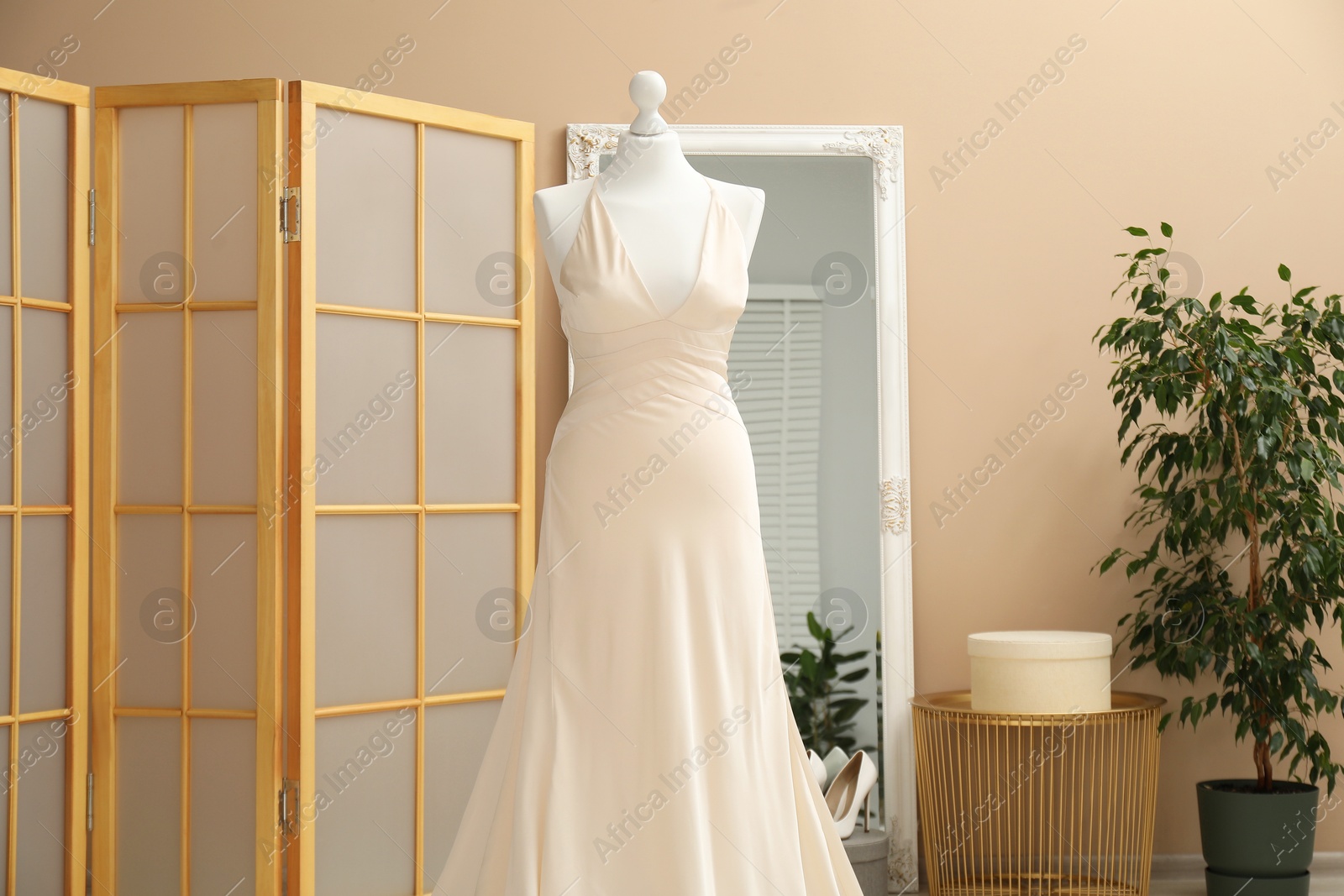 Photo of Beautiful wedding dress on mannequin in boutique